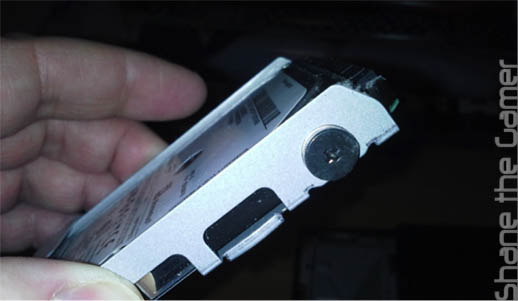 Carefully pull out the metal mounting bracket containing the hard drive.