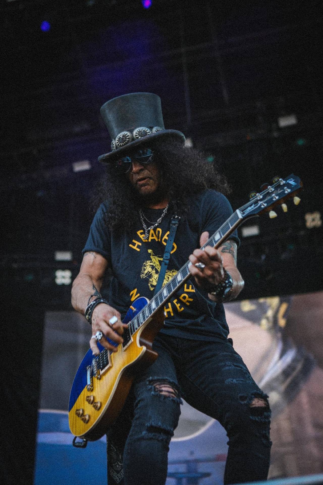 Slash performing with Guns N’ Roses in June with a Gibson Guitars For Peace Les Paul Custom guitar.